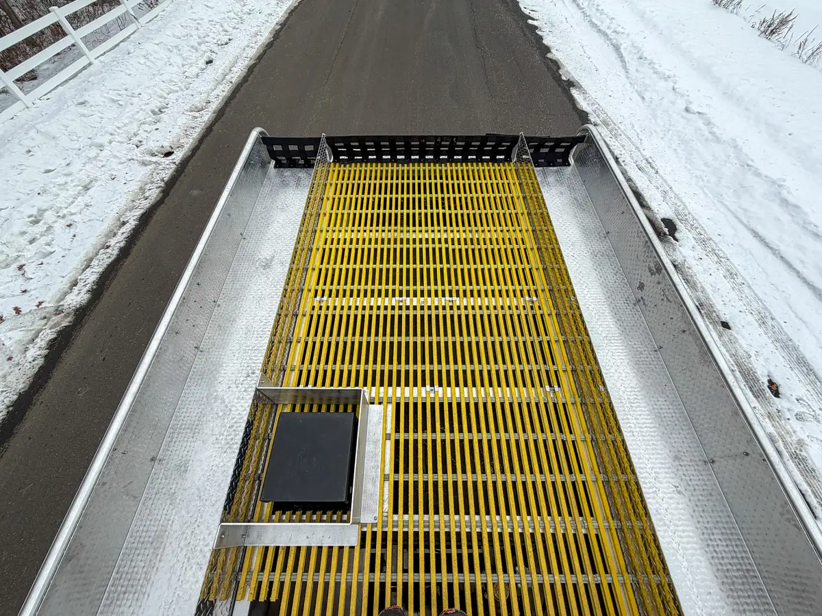 Upper deck with yellow grating and mounted side compartment lids.